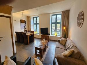a living room with a couch and a table at Spacious Durbuy Apartment for 6 in Durbuy