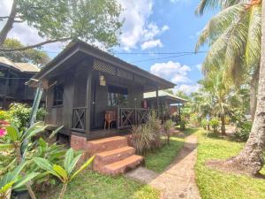 a small house with stairs leading up to it at Nazri's Place 2 in Tioman Island