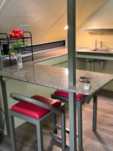 a table and two stools at a kitchen counter at D'Schnuggs Place in Panglao Island