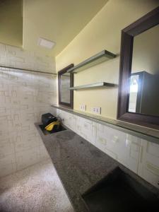 a bathroom with a mirror and a window on the wall at D'Schnuggs Place in Panglao Island +16 photos