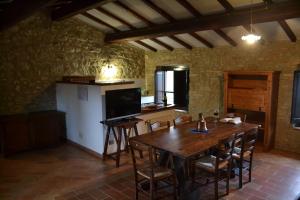 a kitchen with a wooden table and chairs in a room at Agriturismo Nestore in Nestore