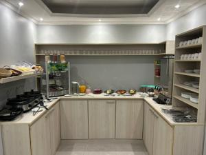 a large kitchen with wooden cabinets and counters at Arion Hotel Sapopemba in São Paulo