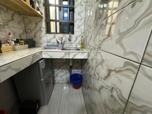 a kitchen with a sink and a counter top at Jajoux Homes in Azohoué-Hiho +7 photos