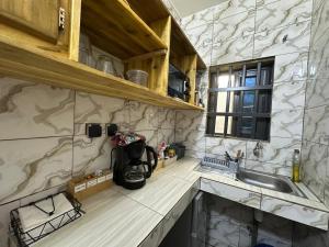 a kitchen with a sink and a counter at Jajoux Homes in Azohoué-Hiho