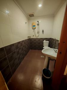 a bathroom with a shower and a sink and a toilet at Swing & Pillows - Dataran Nilai in Nilai