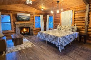 a bedroom with a bed and a fireplace in a log cabin at Timber Wood, Log Cabin, Private Hot Tub, WiFi, Fireplace in Sevierville +11 photos