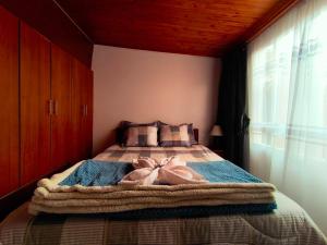 a bedroom with a bed with a dress on it at Luma Dorada in Bogotá