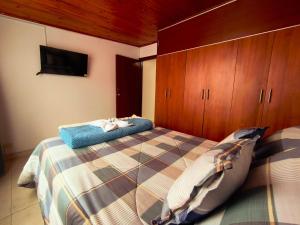 a bedroom with a bed and wooden cabinets at Luma Dorada in Bogotá