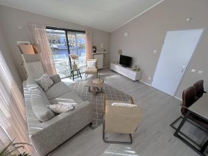a living room with a couch and a table at Aquaronde 125 in Lemmer