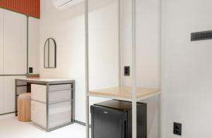 a room with white walls and a counter with a desk at 그루브 호텔 Groove Hotel in Jeonju
