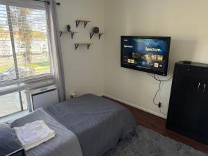 a bedroom with a bed and a flat screen tv at Carson in Carson