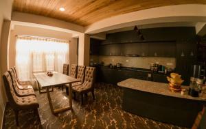 a kitchen with a table and chairs and a counter at Hello Home in Pelling