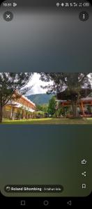 a screenshot of a picture of a house and a tree at Kings guest house in Tuktuk Siadong