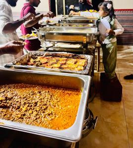 a buffet line with many trays of food at Wadi Rum Main Road Visitor Center in Disah