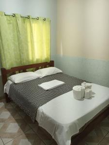 a bedroom with two beds with towels on them at Casa com Piscina Privativa e Churrasqueira in Araruama