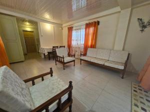 a living room with couches and chairs and a table at Pleasant House in Mount Pleasant