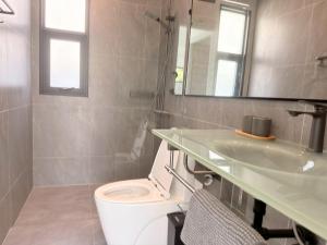 a bathroom with a toilet and a sink and a mirror at Akara Poolvilla Naithon Beach in Ban Sakhu +16 photos