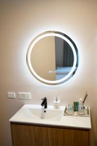 a bathroom sink with a large mirror on the wall at De'Vine Escape in Dixons Creek +22 photos