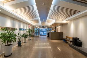 a hallway with potted plants in an office building at New Jeju Hotel in Jeju