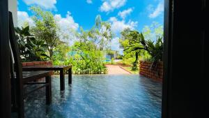 a view from the door of a house with a bench at Aloria Sigiriya in Sigiriya