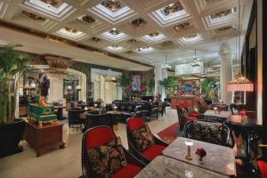 a lobby of a hotel with chairs and tables at Capella Hanoi in Hanoi