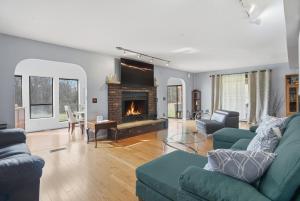 a living room with a couch and a fireplace at Summit Sanctuary with EV Ready Mountain Views in Poughkeepsie