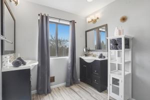 a bathroom with two sinks and a mirror at Summit Sanctuary with EV Ready Mountain Views in Poughkeepsie +80 photos