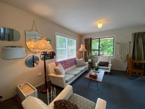 a living room with a couch and a table at Omarama township location - how good! in Omarama