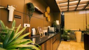 a restaurant with a counter with potted plants at Vanantara Riverside Eco Retreat in Cochin +21 photos