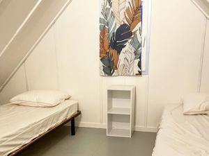 a room with two beds and a painting on the wall at Maison agréable - 6 pers. - API-1-52-2148 in Lattes +21 photos