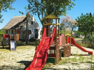 a playground with a slide in front of a building at Maison agréable - 6 pers. - API-1-52-2148 in Lattes