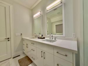 a white bathroom with a sink and a mirror at Modern Luxury Living in Toronto +41 photos