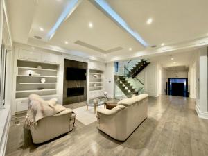 a living room with two couches and a glass table at Modern Luxury Living in Toronto