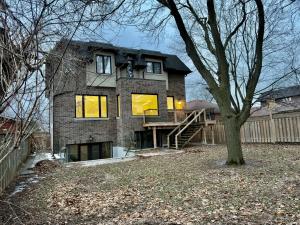 a large brick house with a porch and a tree at Modern Luxury Living in Toronto