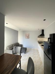 a kitchen and living room with a couch and a table at Grey-B Appartment in Dorp Sint Michiel