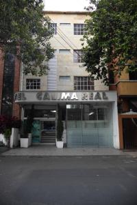 a building with a sign on the front of it at Hotel Calima Real in Cali