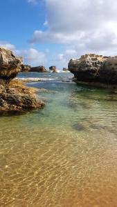 a body of water with rocks in the water at Riverview Coastal Retreat Sleeps 6 Walk to Beach Great Ocean Road in Peterborough