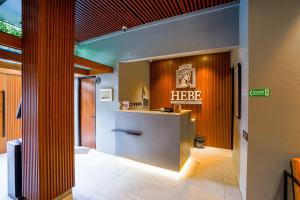 a hotel lobby with a hbcz sign on the wall at Hebe Hotel, Hostel & Hospitality Network in Sawah