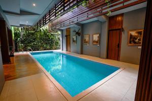 a swimming pool in a house at Hebe Hotel, Hostel & Hospitality Network in Sawah