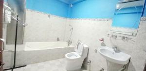 a bathroom with a toilet and a sink and a tub at Second Home Hotel in Kathmandu +19 photos