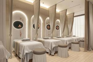 a row of tables in a room with mirrors at Sealand hotel & spa in Dong Hoi
