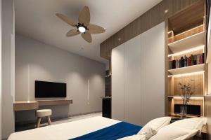 a bedroom with a ceiling fan and a tv at Sealand hotel & spa in Dong Hoi