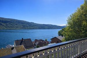 a view of a lake from a balcony at Faleide Panorama Private Fjord View Cabin with Large Terrace in Stryn
