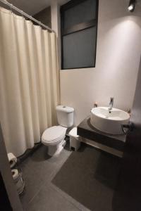 a bathroom with a toilet and a sink at Luke Stay in El Pueblito