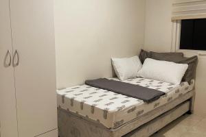 a small bed in a room with at Tropical Themed 2 Bedroom Condo in Mandaue City