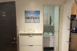 a white bathroom with a sink and a mirror at Tropical Themed 2 Bedroom Condo in Mandaue City +9 photos
