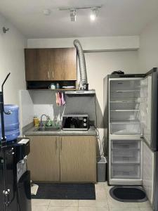 a kitchen with a sink and a microwave at Tropical Themed 2 Bedroom Condo in Mandaue City