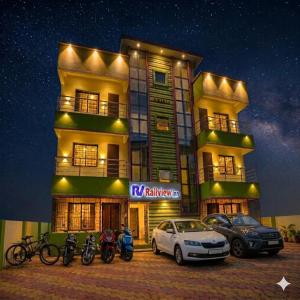 a building with bikes and cars parked in front of it at Railview inn Bhubaneswar in Bhubaneshwar