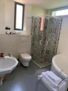 a bathroom with a shower and a toilet and a sink at La Bergerie Isolabella sea view B & B in Taormina +51 photos