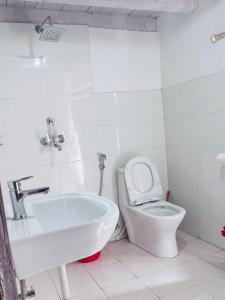 a white bathroom with a sink and a toilet at Hotel Dancing Yak in Jomsom +47 photos